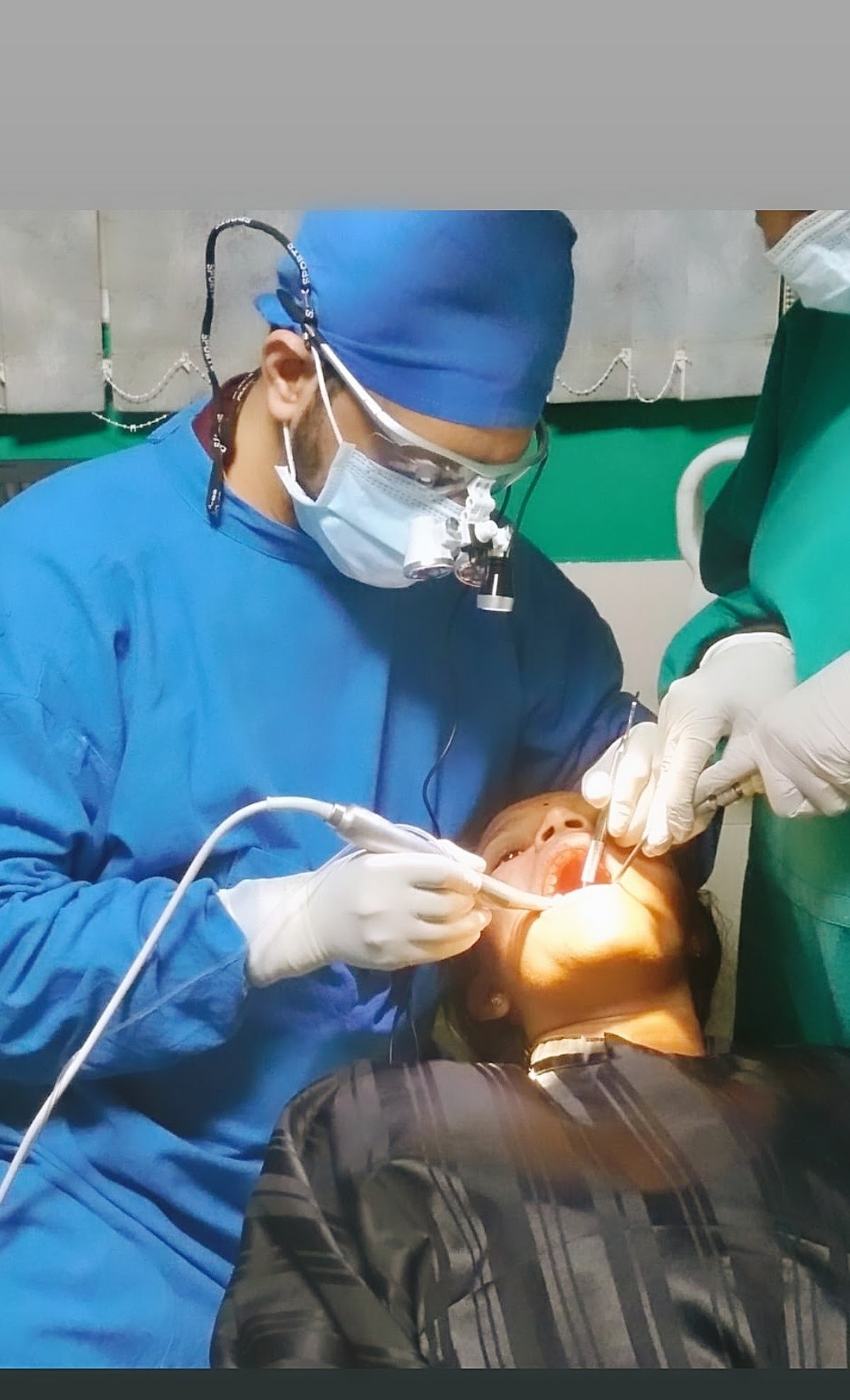 Dentist and assistant performing a procedure on a patient